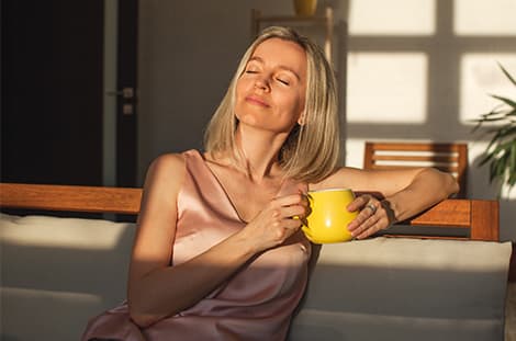 Christina smiling with a mug