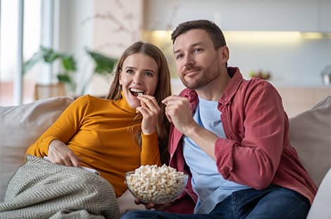 Tamara and her partner eating popcorn