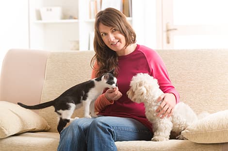 Krissy sitting with two pets